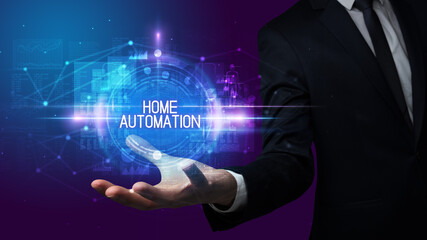 Man hand holding HOME AUTOMATION inscription, technology concept