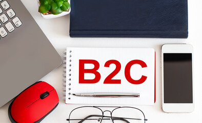 Poster - B2C text on the notepad,pen, office tools on the white background. Business concept
