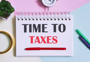 Poster - TIME TO TAXES text written on a notebook with pencils, magnifier