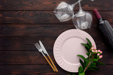 Valentine's day table setting with plate, wine and glasses