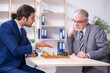 © Elnur - Two businessmen playing chess in the office