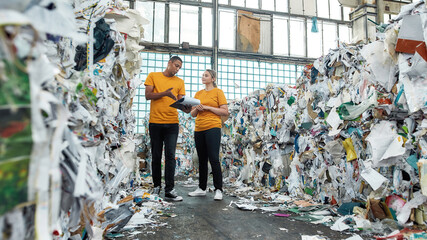 Man working with girl on waste disposal station