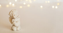 Figurine Of An Angel Cupid With A Bow On A Pink Background. Valentine's Day.