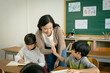 © JR-50 - Women teacher and an elementary boy school clapping together hands.
