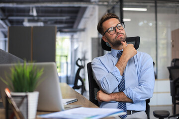 Sticker - Focused businessman thinking at modern office into report file calculating stock market earnings, startup business.