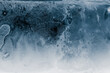 Ice texture background. Textured cold frosty surface of ice block on dark background.