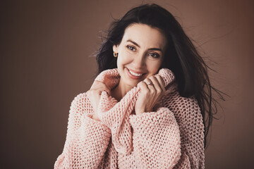 Portrait of beautiful middle aged woman wearing warm woolen sweater