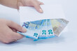 © Дина Морозова - white envelope with 20 and 50 Euro banknotes in a woman's hand