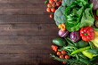 Fresh organic vegetables on a wooden background with copy space. Top view