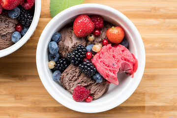 Ice cream with fruit in a white bowl. Summer dessert.