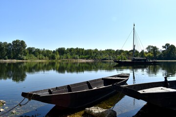 wooden boats chained to beach