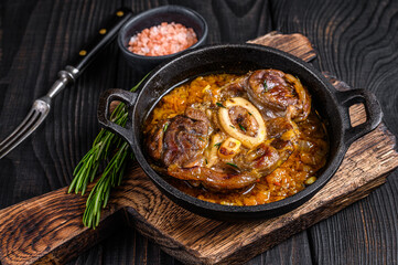 Wall Mural - Stew veal shank meat OssoBuco,  italian osso buco steak. Black wooden background. Top view