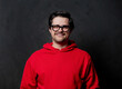 © Masson - White nerd guy in red sweatshirt on dark background