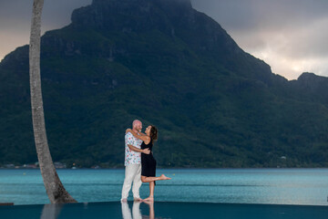 Happy couple in love on a romantic vacation at tropical island Bora Bora in French Polynesia