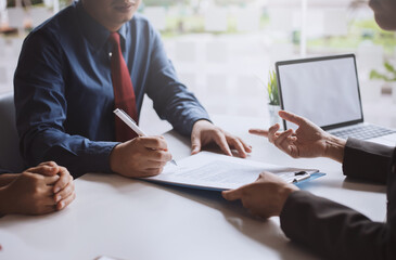 Signing a business contract. Group of business people at the meeting and sign a together business investment agreement..