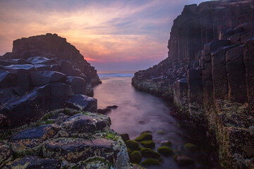 Colourful sunrise over Fingal Causeway . An amazing formation of basalt rock columns at Fingal Head ,Northern Rivers Region of N.S.W. Australia.