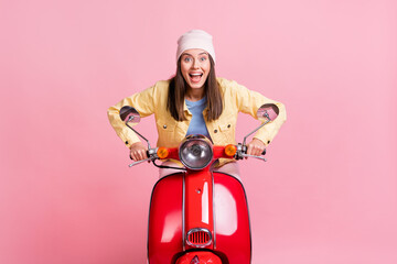 Sticker - Photo of young happy smiling happy crazy girl woman female ride fast red motorbike isolated on pink color background