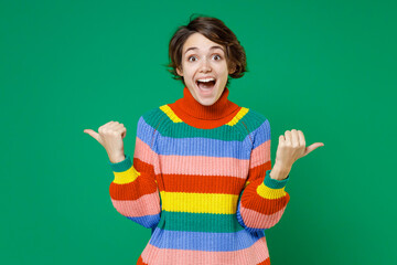 excited shocked young brunette woman 20s years old wearing casual basic colorful sweater standing po