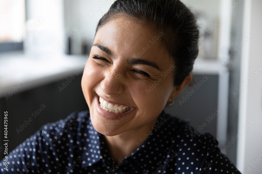 Crop close up of overjoyed millennial 20s Indian woman laugh at funny joke. Happy excited young mixed race ethnicity female have fun smiling at home, feel satisfied glad with good news. Humor concept. - obrazy, fototapety, plakaty 