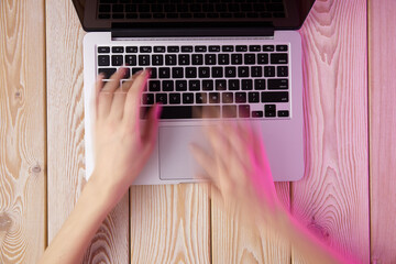 Poster - Image of woman’s hands typing fast on laptop keyboard. View from above. Remote work concept image.
