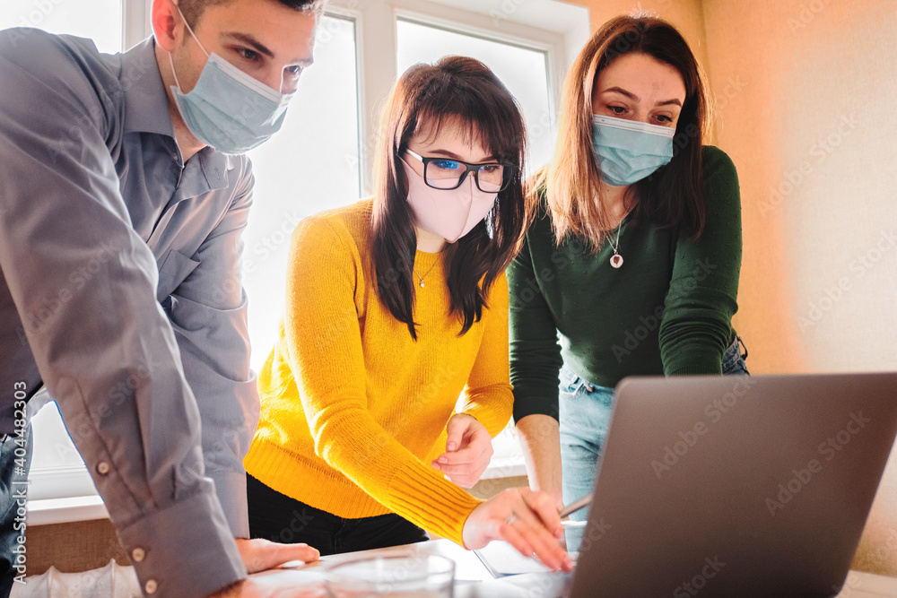 A group of young employees create a startup amid the COVID-19 pandemic and wear face masks - Business and collaboration in an alternative office - Colleagues meeting in the office - obrazy, fototapety, plakaty 