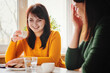 © sergign - Two girls friends drink coffee and have fun in a cafe - Girlfriends have fun in a coffee shop - Happy friends chat and gossip at the table and drink coffee
