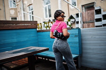Urban Young African American Woman In Pink Top And Grey Jeans And Sunglasses With Handbag. Afro Fashion Chic Women.