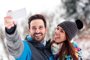 Wall Mural - Couple taking a selfie in the nearby woods