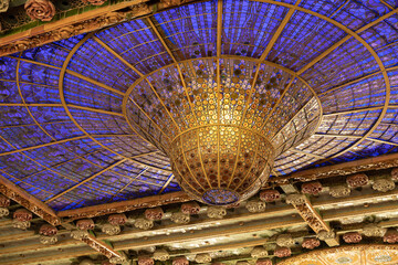 Stained-glass skylight of the Palau de la Musica Catalana's modernisme interior looks like a lamp or the Chandelier