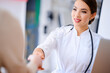 © khmelev - Female doctor shaking hands with the patient in the office