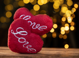 Heart shape on brown wood table with yellow light  bokeh backgrounds