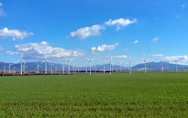 Renewable energy. Wind power plant with turbines against blue sky. Windmill energy transformation