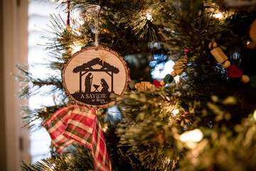 Closeup of Nativity Christmas Ornament hanging on a Decorated Christmas Tree