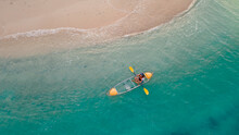 Blue Sea With Floating Transparent Kayak Near Sand Beach, Person With Life Jacket On Boat