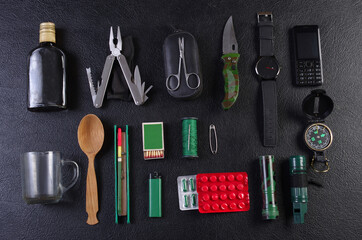 Wall Mural - Set of items for survival in nature. Dark background.