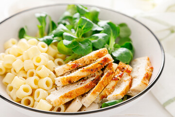 Wall Mural - Grilled chicken breast, pasta and fresh lamb salad in lunch bow