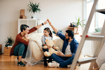 Wall Mural - Happy parents with daughter moving into a new apartment.