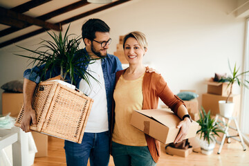 Wall Mural - Portrait of a happy couple relocating into a new home.