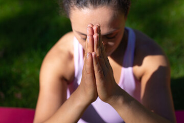 Closeup of hands of woman doing Yoga meditation exercises outdoor