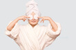 © Svetlana - Smiling beautiful kid girl with towel on head hold cotton pad disk cleansing face skin with cleanser isolated on white background. Happy girl remove makeup look at camera enjoy healthy clean skincare