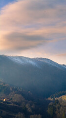 Wall Mural - landscape with mountains and clouds at sunrise