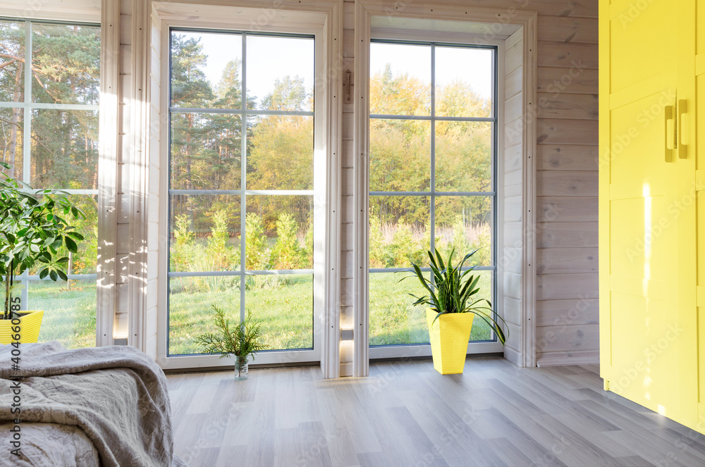 Bright interior, room in wooden house with large window. Scandinavian style. The trendy colors of 2021 are gray and yellow - obrazy, fototapety, plakaty 