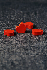 Red wooden hearts on gray surface