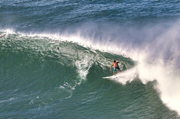 Unidentifiable surfer seen from above on an active and energetic surf day.