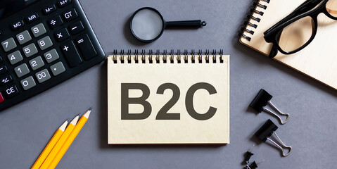 Poster - Notepad with inscriptions B2C on a grey background with office tools . business concept.