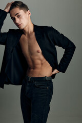 man in a black unbuttoned jacket muscular abs attractive look