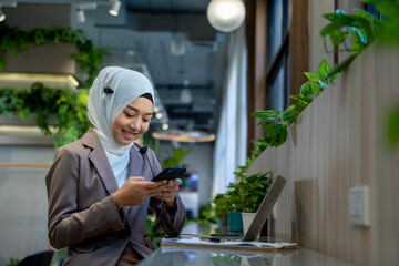 Wall Mural - Smiling Indian female employee with headset working and talk on video call,have web conference with colleagues.