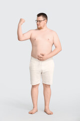 Sticker - Overweight man on grey background. Weight loss concept