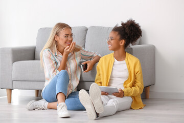 Wall Mural - Teenage girls with different devices at home