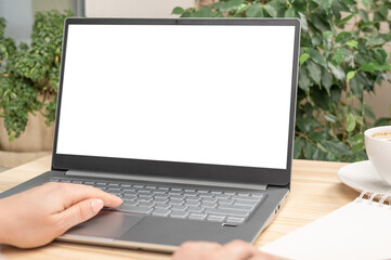 Poster - Mockup image of a woman using and touching on laptop computer touchpad with blank white desktop screen on wooden table